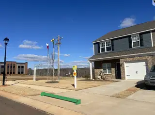A charming brick and siding home with manicured lawn in Autumn Brook by Profile Homes (Stanley, NC).