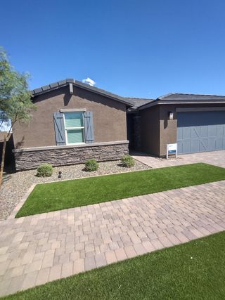 Charming home with stone accents and shutters in Paloma Creek by Meritage Homes (Surprise, AZ).