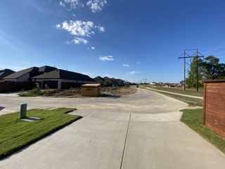 A developing neighborhood with new homes and clear skies in Solterra by Impression Homes (Mesquite, TX).