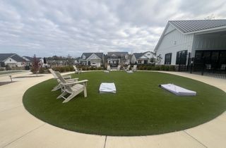 A vibrant community space with seating and greenery in Cresswind Wesley Chapel by Kolter Homes (Monroe, NC).
