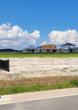 Newly constructed homes with spacious lots in Westview: Aden South II by Lennar in Kissimmee, FL, under a clear blue sky.