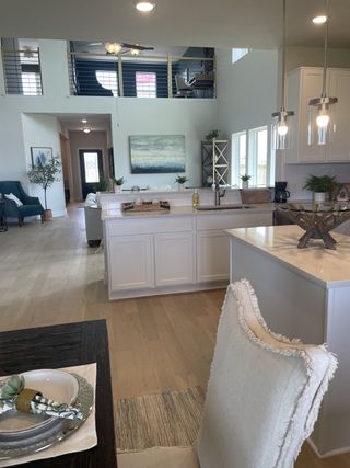 An elegant open-concept living space with high ceilings, modern fixtures, and stylish décor.