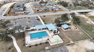 Community Amenities Aerial view of community amenities in Meyer Ranch by Princeton Classic Homes, featuring a pool and recreational areas (New Braunfels, TX).