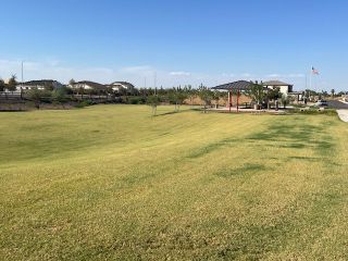 Community Amenities Expansive green space and pavilion in Laveen Vistas III by Homes by Towne, Laveen, AZ, perfect for community activities.