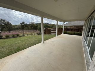 A spacious backyard with a covered patio, perfect for outdoor relaxation and entertaining.