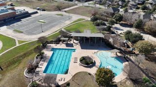 Community Amenities Aerial view showcasing a vibrant pool and playground in Blanco Vista by Pacesetter Homes, San Marcos, TX.