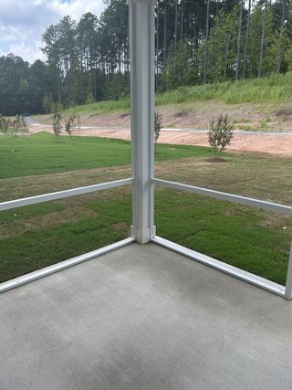 A serene screened patio with lush backyard views, perfect for enjoying the outdoors in comfort.