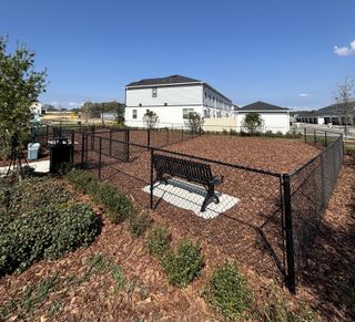 Community Amenities A spacious fenced dog park with benches, open play areas, and beautiful landscaping in Emerson Pointe by M/I Homes (Apopka, FL).