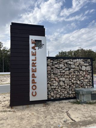 Street view Modern entrance sign with sleek stone design at Copperleaf by Ryan Homes in Ocala, FL.