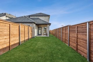 A charming home with a fenced backyard and patio in Solterra by Impression Homes (Mesquite, TX).