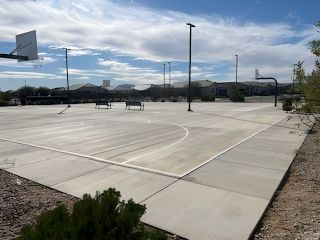 Spacious outdoor basketball courts under a bright sky in Seasons at Rio Rancho by Richmond American Homes (Surprise, AZ).