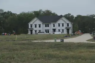 A new two-story home under construction in Painted Tree - Woodlands District by CB JENI Homes, McKinney, TX.