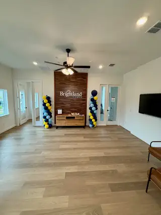 A modern room with wood flooring, elegant decor, and a cozy seating area.