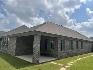 A charming brick home with a covered patio in Jordan Ranch: Pinnacle Collection by Lennar (Fulshear, TX).