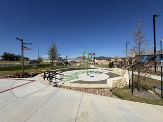 Community Amenities A vibrant community park with splash pad in Nolina 60' by Perry Homes, Georgetown, TX. Perfect for outdoor activities.