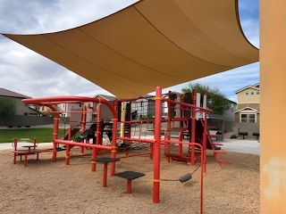 Community Amenities A vibrant playground under a sunshade in Redwood Valley at Escalante by Fulton Homes, Surprise, AZ.