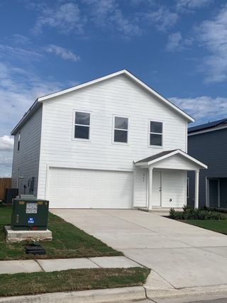 A modern two-story white home in Sunset Oaks by Lennar, offering a clean facade, spacious garage, and fresh landscaping.