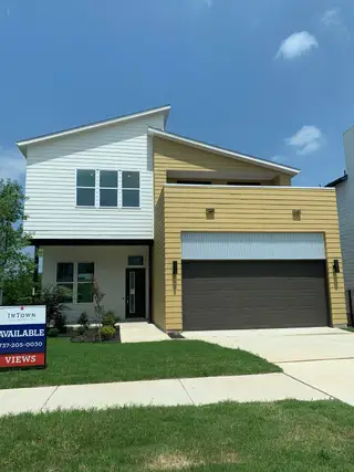 A modern two-tone home with a spacious garage in Agave by InTown Homes (Austin, TX).