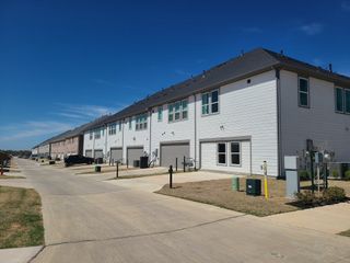 Modern townhomes with clean lines and garages in Village on Main Street by CB JENI Homes (Frisco, TX).