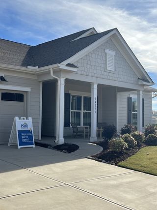 Street view Charming light gray home with elegant columns and a welcoming porch in Parkside Crossing by Pulte Homes (Charlotte, NC).
