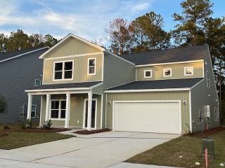 A charming two-story home with a modern exterior in Watson Hill by Ashton Woods (Summerville, SC).