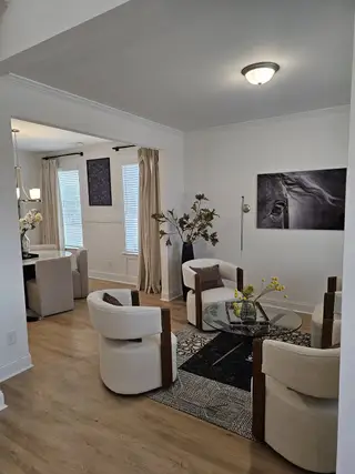 A sophisticated sitting room with contemporary armchairs, a glass coffee table, and stylish décor.