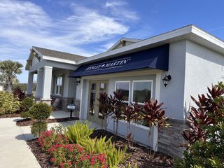 A charming model home with lush landscaping and elegant design in Sunset Lakes Estates by Stanley Martin Homes (Mascotte, FL).