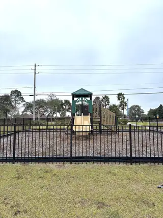 Community Amenities A charming playground with a slide and wood chips in Brookshire by Stanley Martin Homes (Titusville, FL).