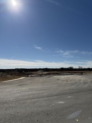 A sunny expanse of asphalt and construction in Bar W Ranch by D.R. Horton, Leander, TX.