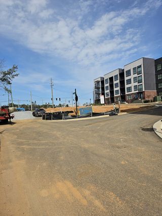 A developing residential area in Skyview On Broad by Kittle Homes (Sugar Hill, GA), featuring luxury townhomes in an urban setting.