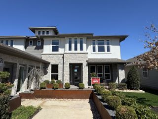 A modern two-story home with elegant stone accents and manicured landscaping in Easton Park 50s by Taylor Morrison (Austin, TX).