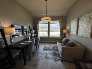 A cozy home office with a modern desk, elegant lighting, and comfortable seating, perfect for productivity and style.