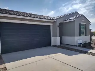A charming modern home with a sleek garage and tiled roof in Paloma Creek by Meritage Homes (Surprise, AZ).
