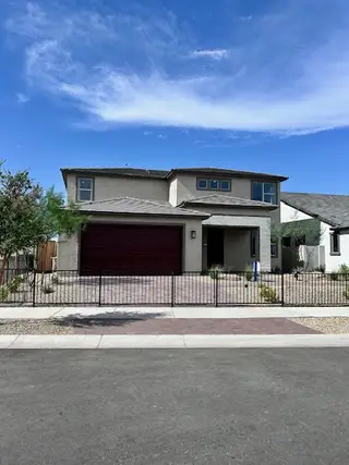 Street view A modern two-story home with a sleek design in The Grove at El Cidro by William Ryan Homes (Goodyear, AZ).