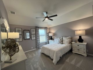 Model Home A soft-toned bedroom featuring classic furnishings and stylish wall art.