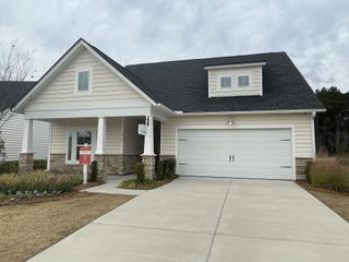 Street view A charming home with stone accents and a two-car garage in Horizons at Summers Corner by Lennar (Summerville, SC).