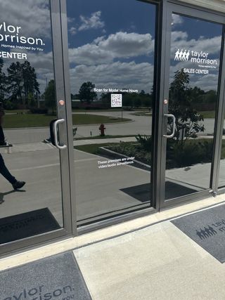 Street view Taylor Morrison Sales Center with reflective glass doors in Raburn Reserve 50s by Taylor Morrison, Tomball, TX.