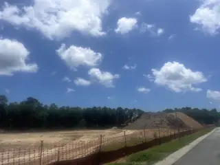 Construction underway in Miller's Crossing by Dream Finders Homes, Johns Island, SC, under a beautiful cloudy sky.