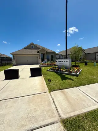 Street view A charming home with manicured gardens and a two-car garage in Lago Mar: Bristol Collection by Lennar (Texas City, TX).