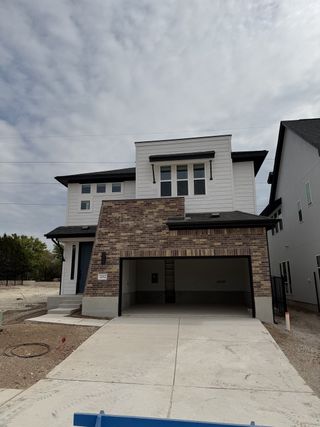 A modern two-story home with mixed brick and siding in Foxfield by Milestone Community Builders (Austin, TX).