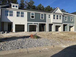 Modern townhomes with dual-colored siding in Boykins Run Townhomes by DRB Homes (Moncks Corner, SC).