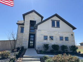Charming stone facade home with manicured landscaping in The Parklands by Coventry Homes, Schertz, TX.