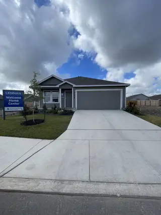 Street view Modern single-story home with a gray facade in Torian Village: Watermill Collection by Lennar (San Antonio, TX).