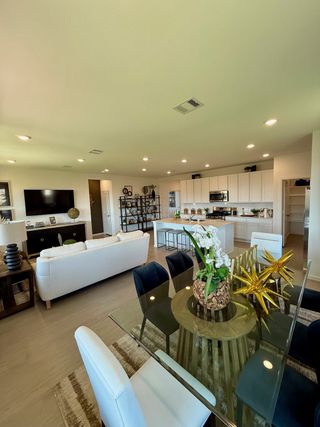 An open-concept living and dining area with modern furnishings, sleek finishes, and stylish decor.