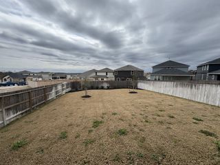Spacious fenced backyard with serene views in Hunters Ranch by Legend Homes, San Antonio, TX.