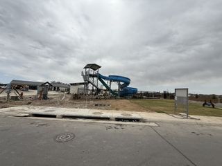 A vibrant community pool with a slide in Riverstone at Westpointe by D.R. Horton in San Antonio, TX.