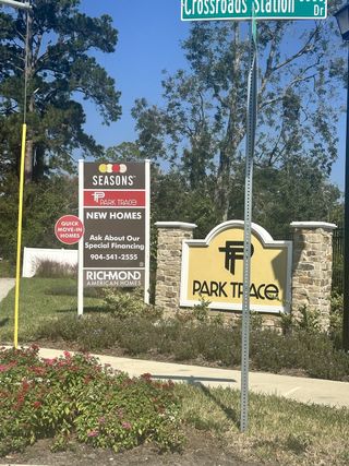 New homes available in Seasons at Park Trace by Richmond American Homes, Jacksonville, FL. Lush greenery and welcoming sign.