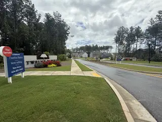 A welcoming entrance to Twelve Parks 55+ by Lennar, featuring lush greenery and a vibrant community in Sharpsburg, GA.