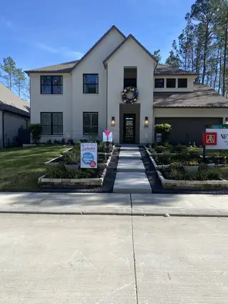 A modern home with a festive wreath and manicured lawn in ARTAVIA® - 60' by Westin Homes (Conroe, TX).
