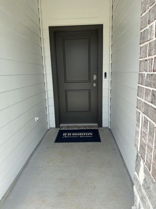 Model Home A welcoming entrance with a sleek dark door and a D.R. Horton mat, located in Silverthorne by D.R. Horton (Conroe, TX).